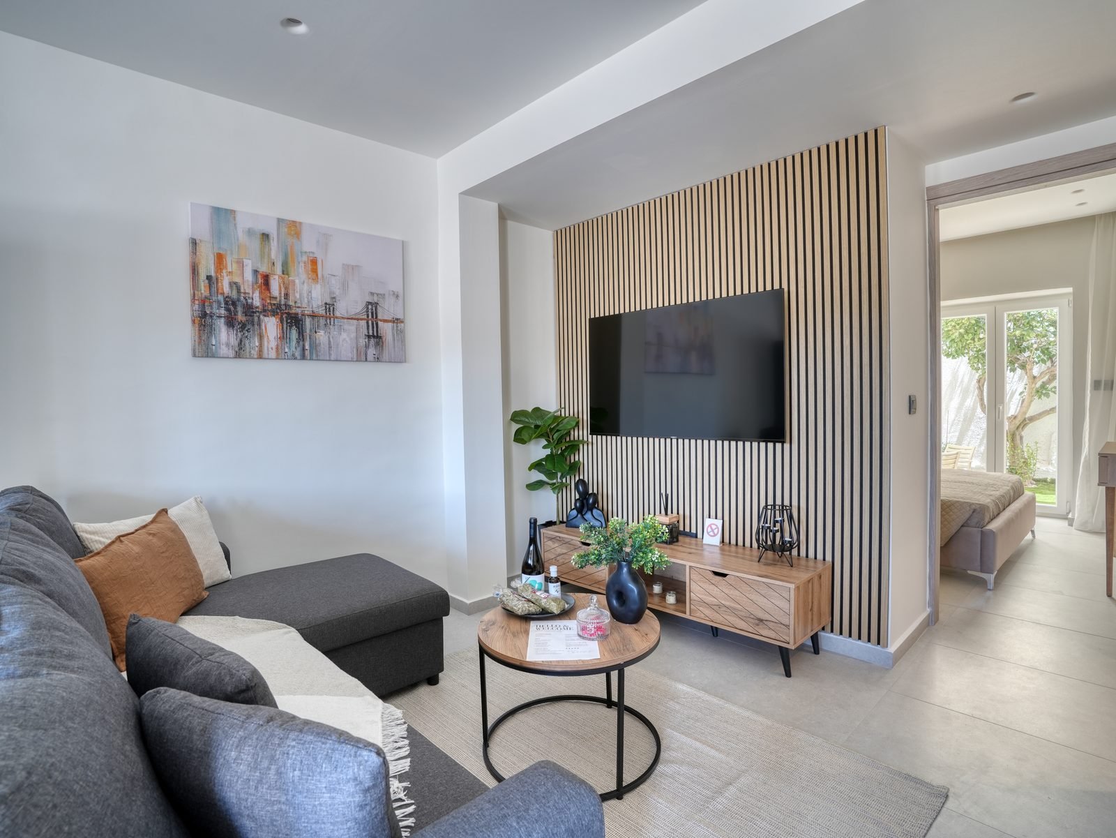 Comfortable living room with sofa and wood-slat TV wall