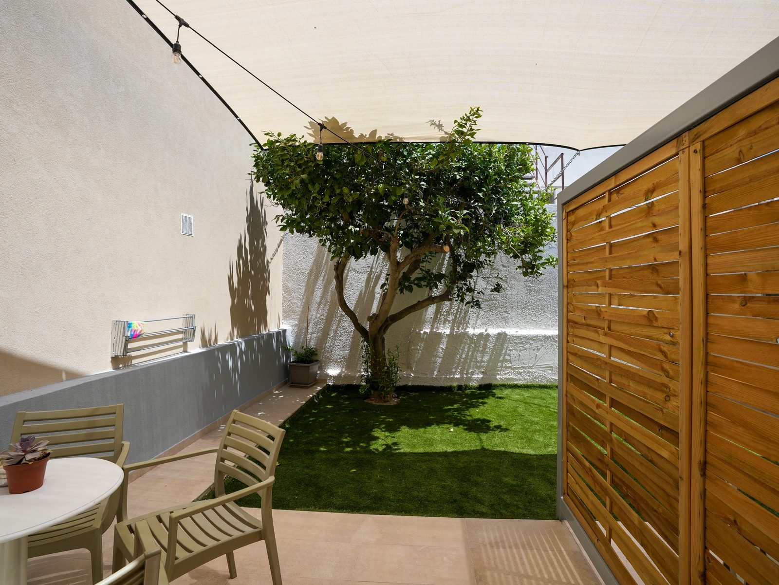 Private garden courtyard with tree and seating